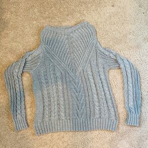 A cute gray sweater with holes on the shoulders!